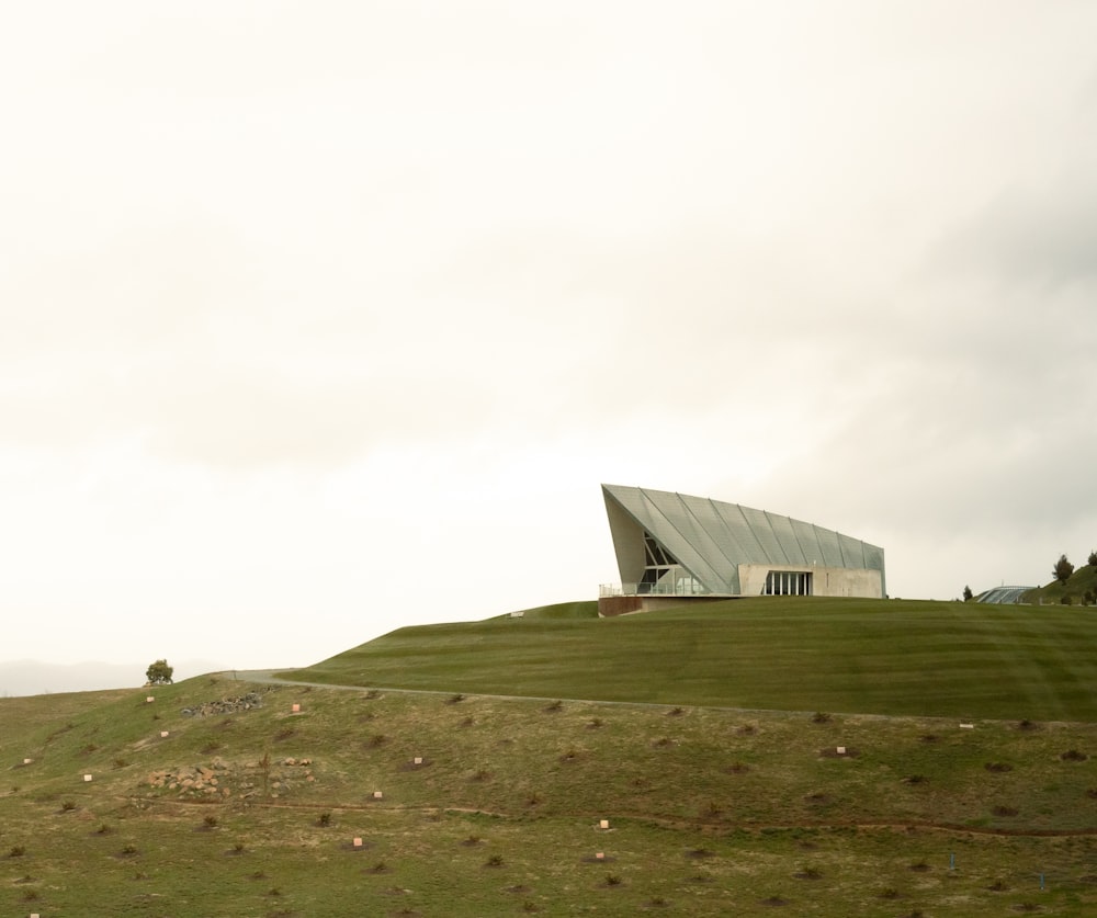 white building on green grass field under white sky during daytime