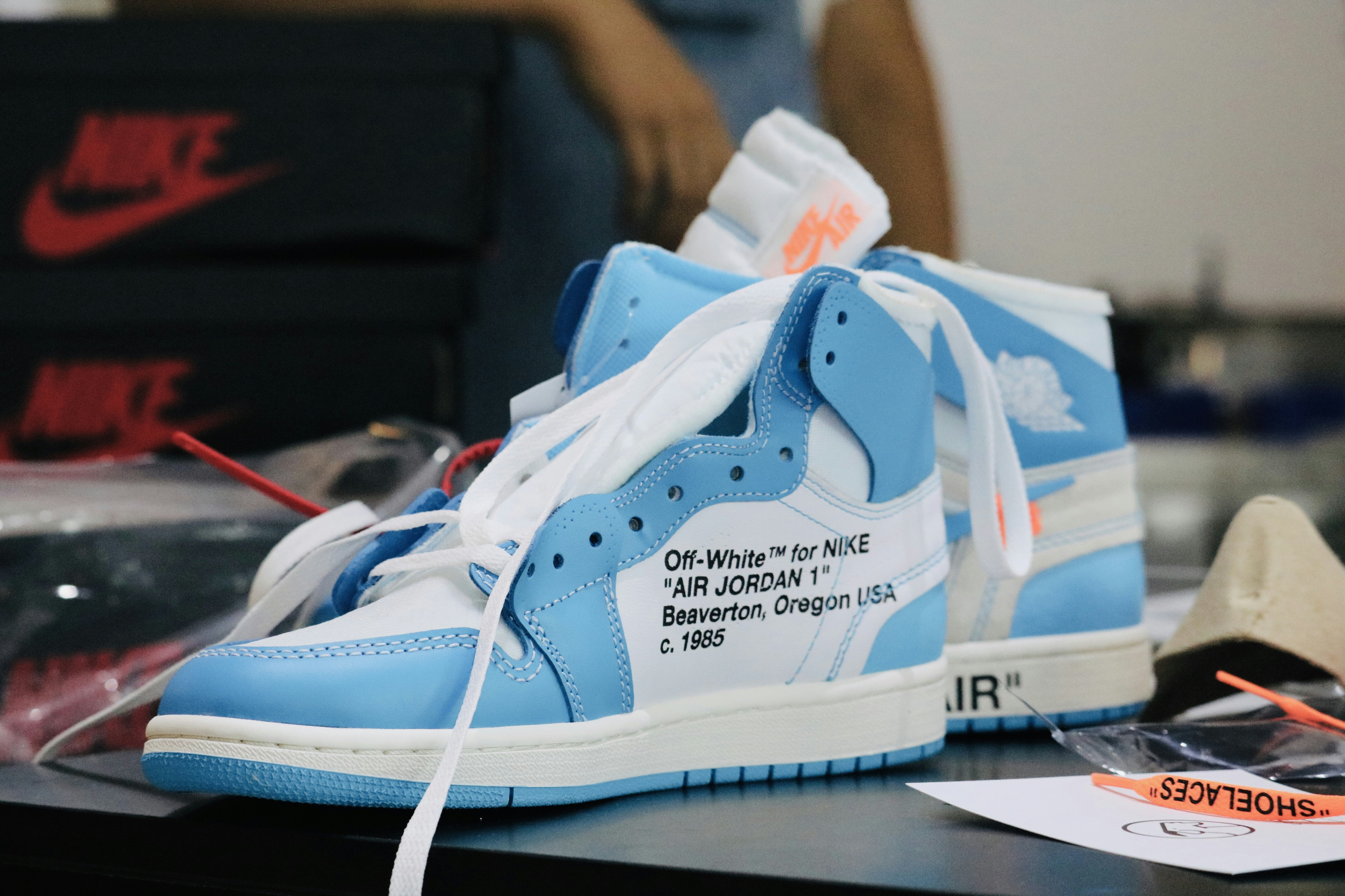 a pair of blue and white sneakers on a table