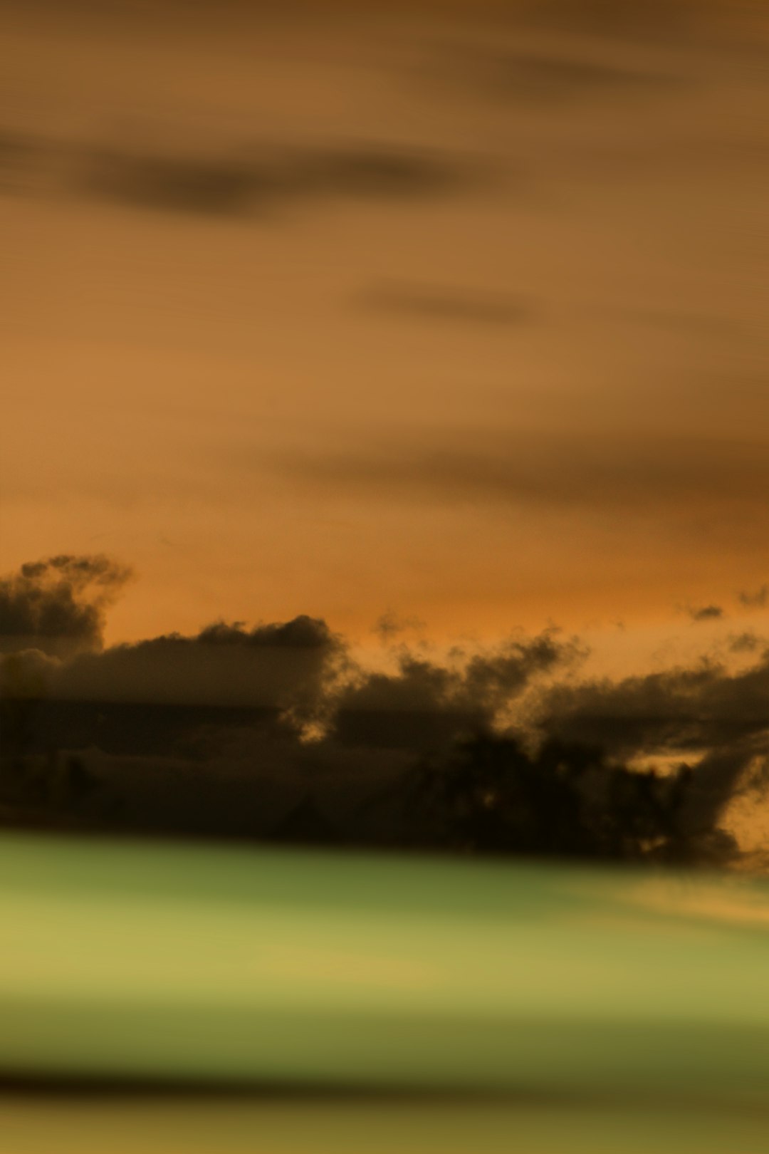 clouds over green grass field