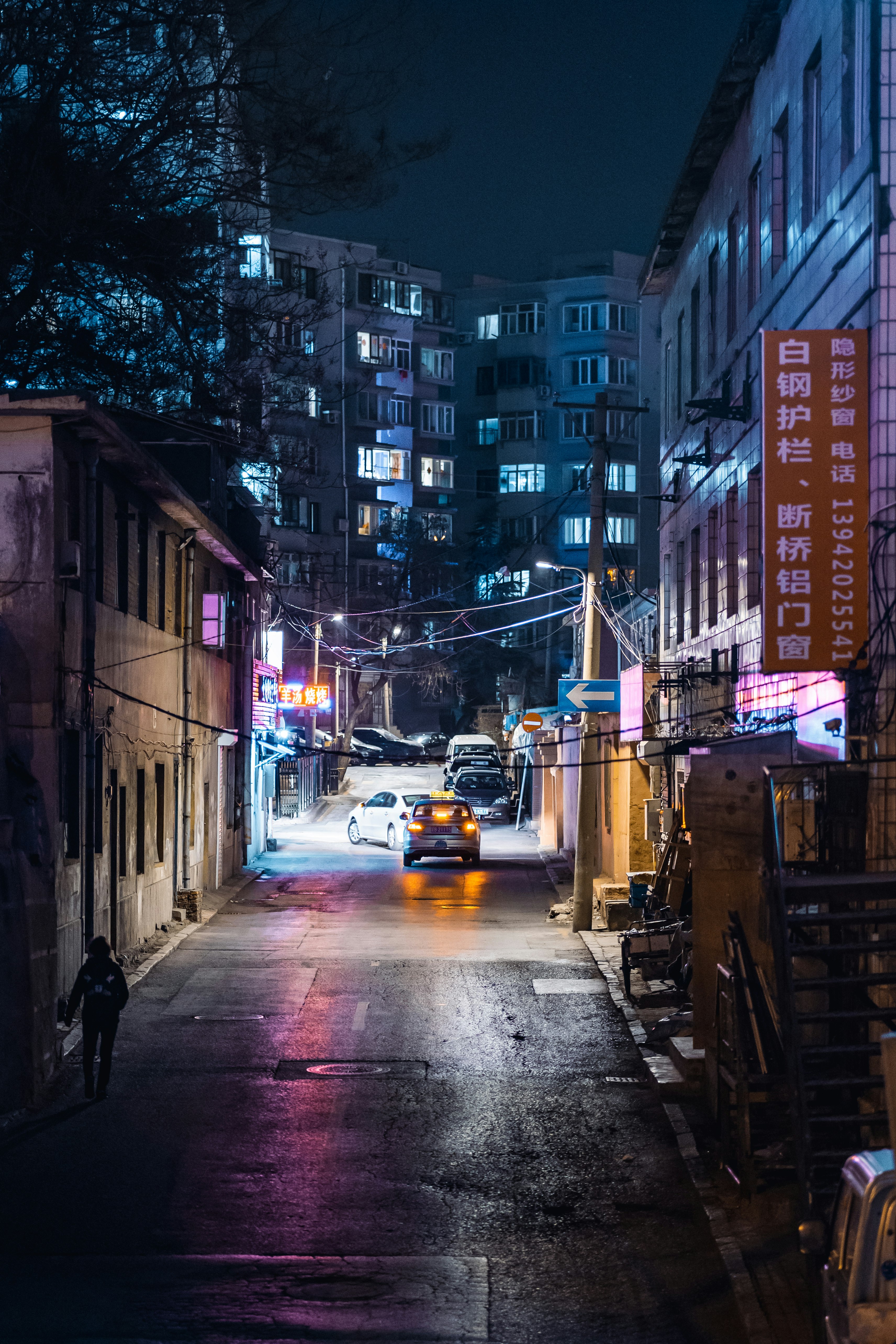 cars on road between buildings during daytime