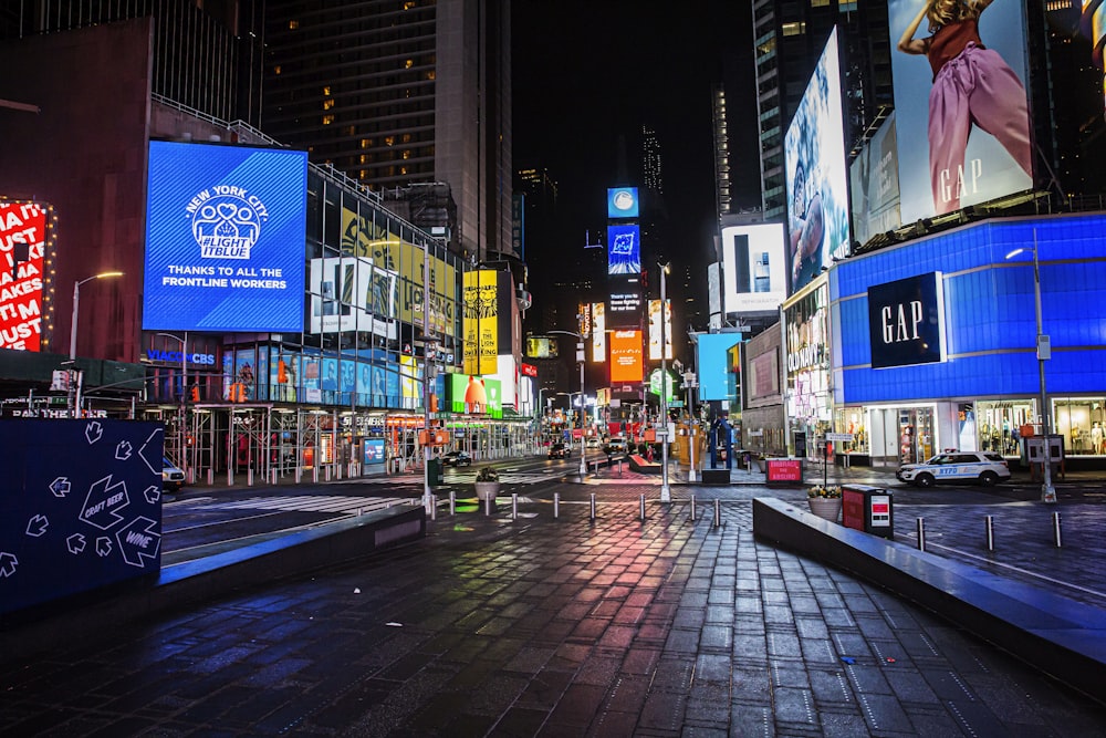 people walking on sidewalk during night time