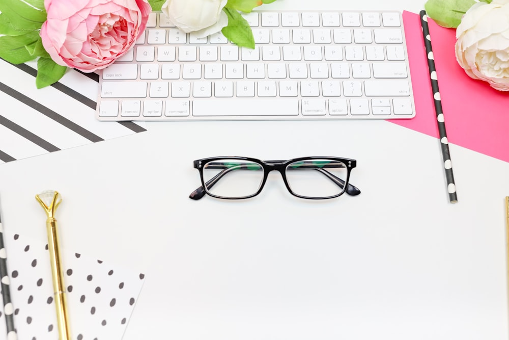 black framed eyeglasses on white paper