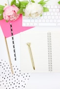white and pink rose on white paper