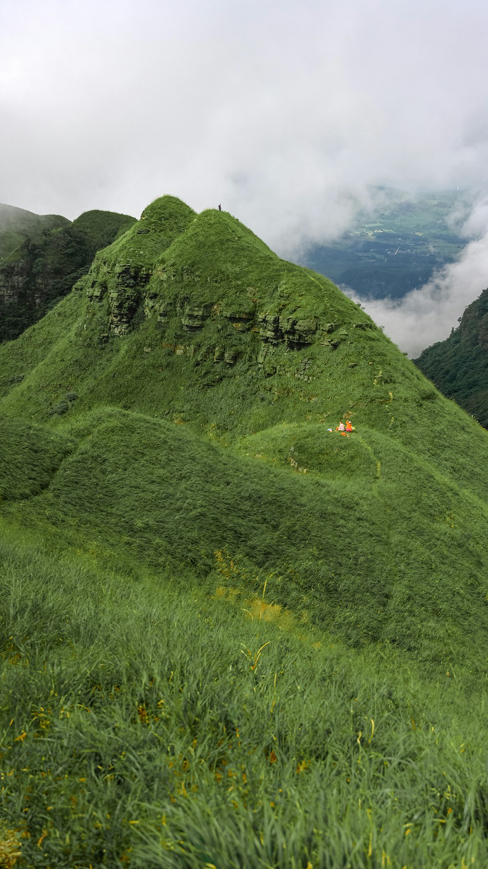 green mountain under white clouds during daytime