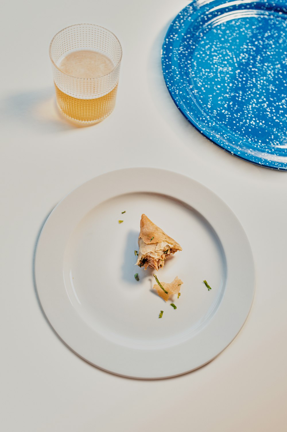 white and blue ceramic plate with brown and white cupcake