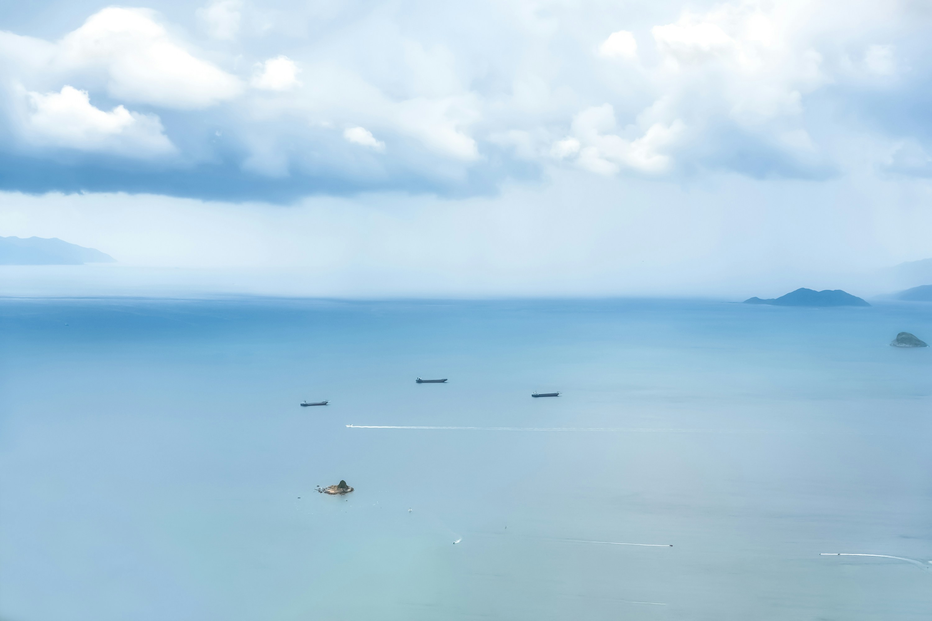 birds flying over the sea during daytime