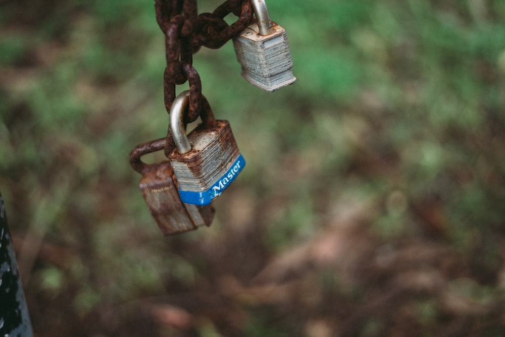 silver padlock on brown metal chain