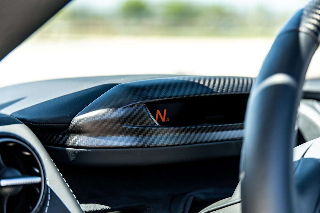 black car steering wheel during daytime