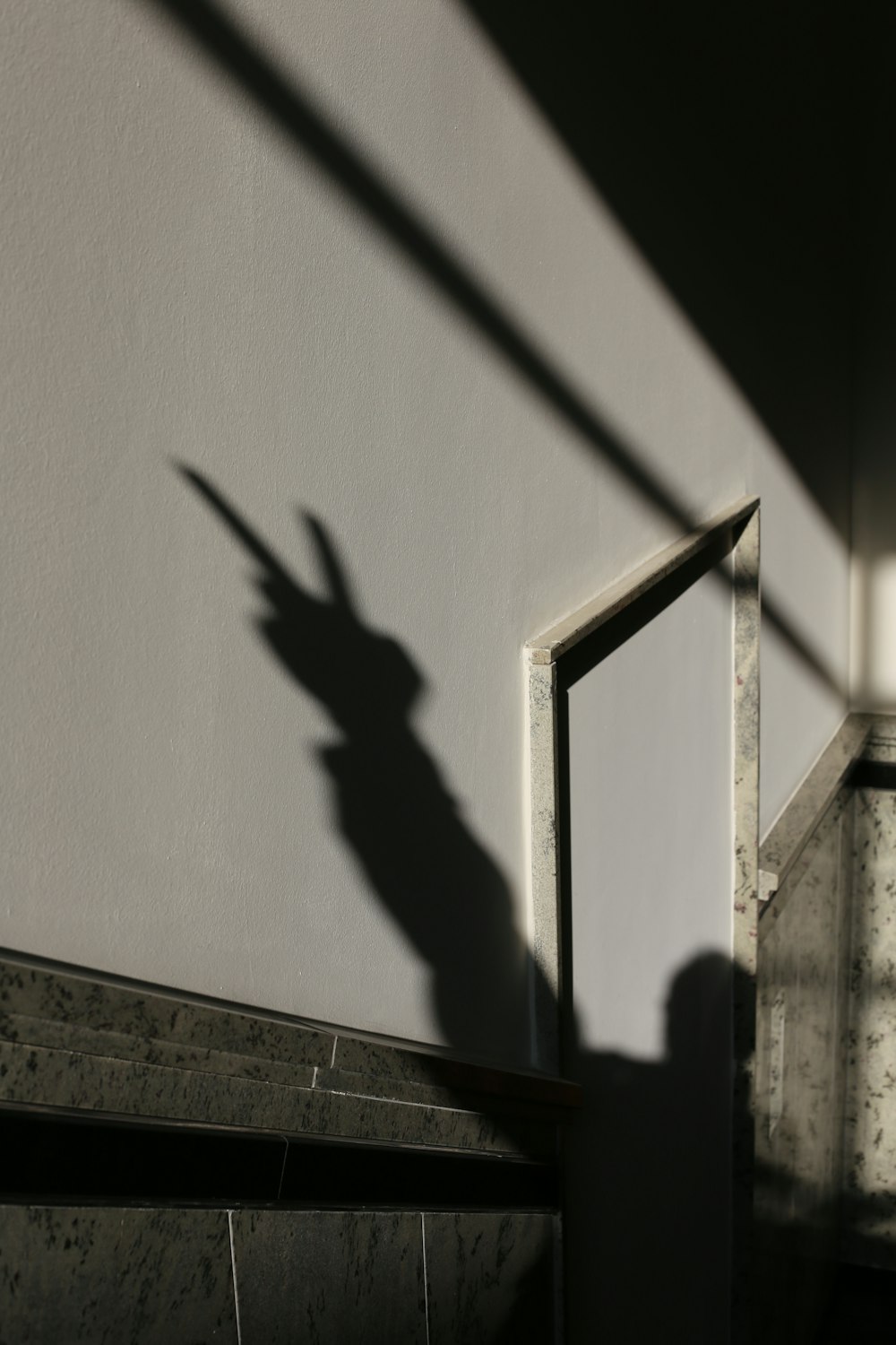 shadow of person on white wall
