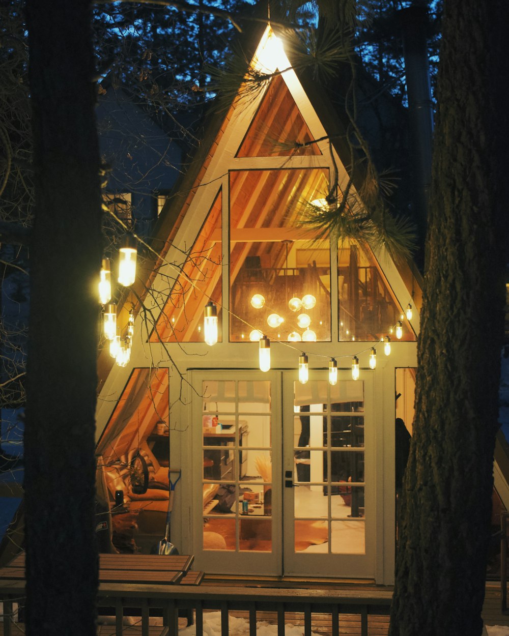 a small house with lights hanging from it's roof