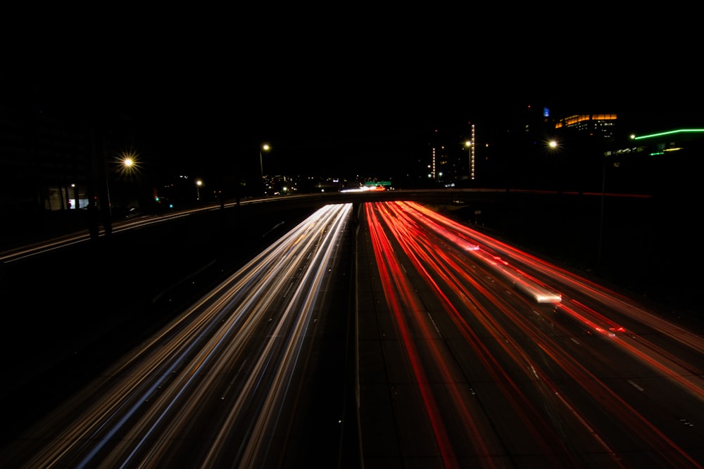 a long exposure photo of a highway at night