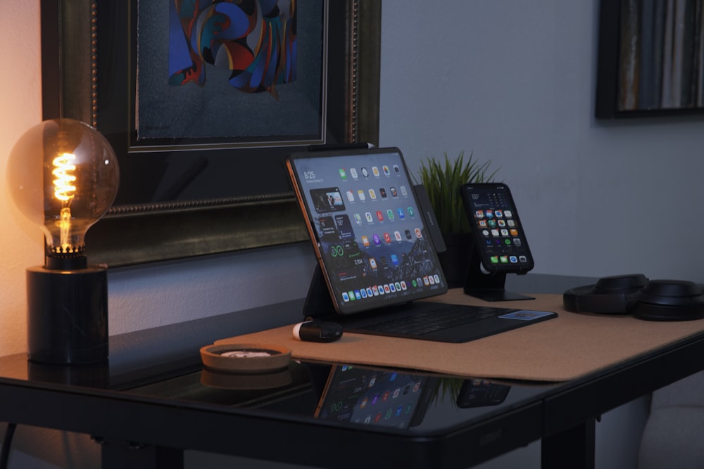 a laptop computer sitting on top of a wooden desk