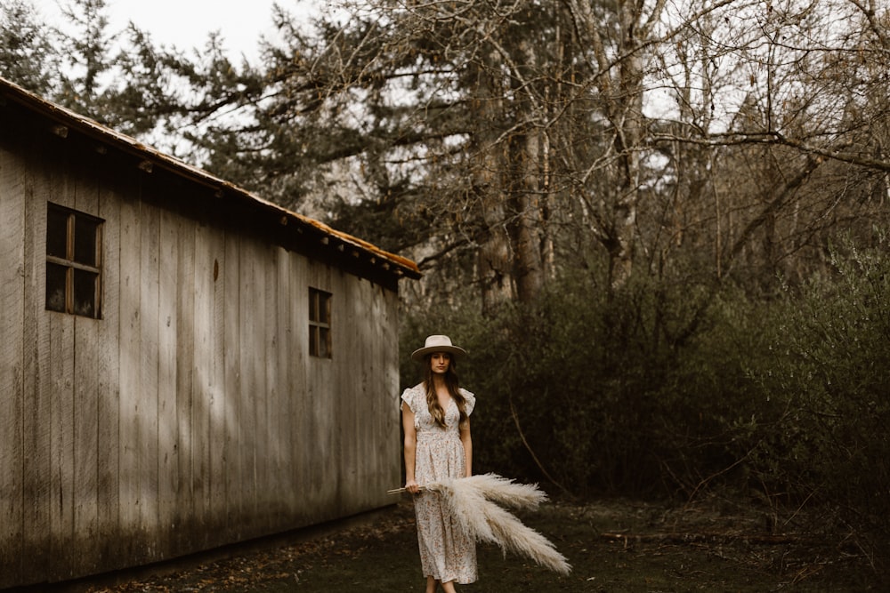 woman in white dress standing on wooden bridge