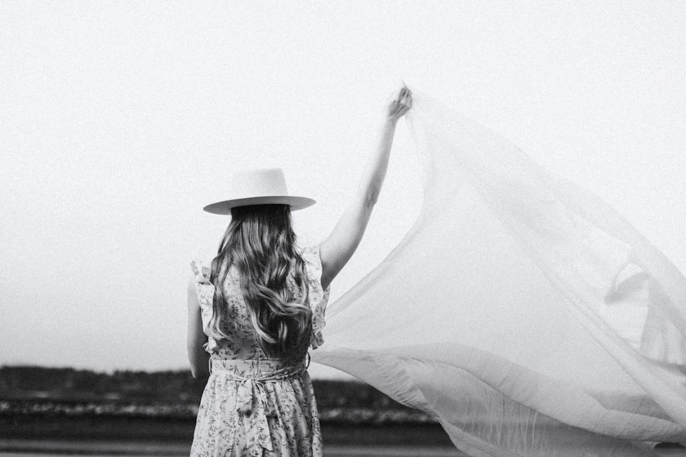 woman in white floral dress wearing hat