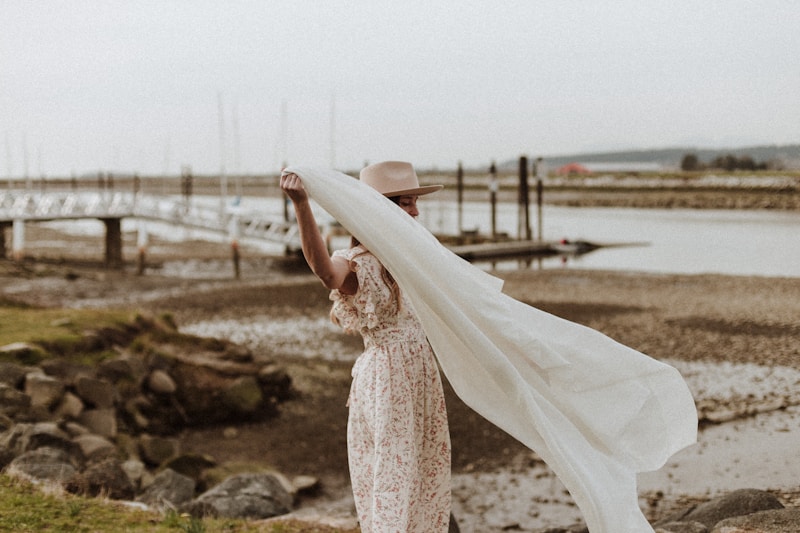 Chic woman in floral dress on rock