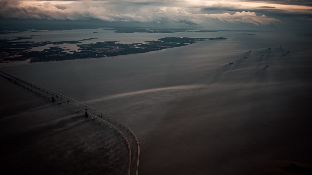 aerial view of road near body of water during daytime