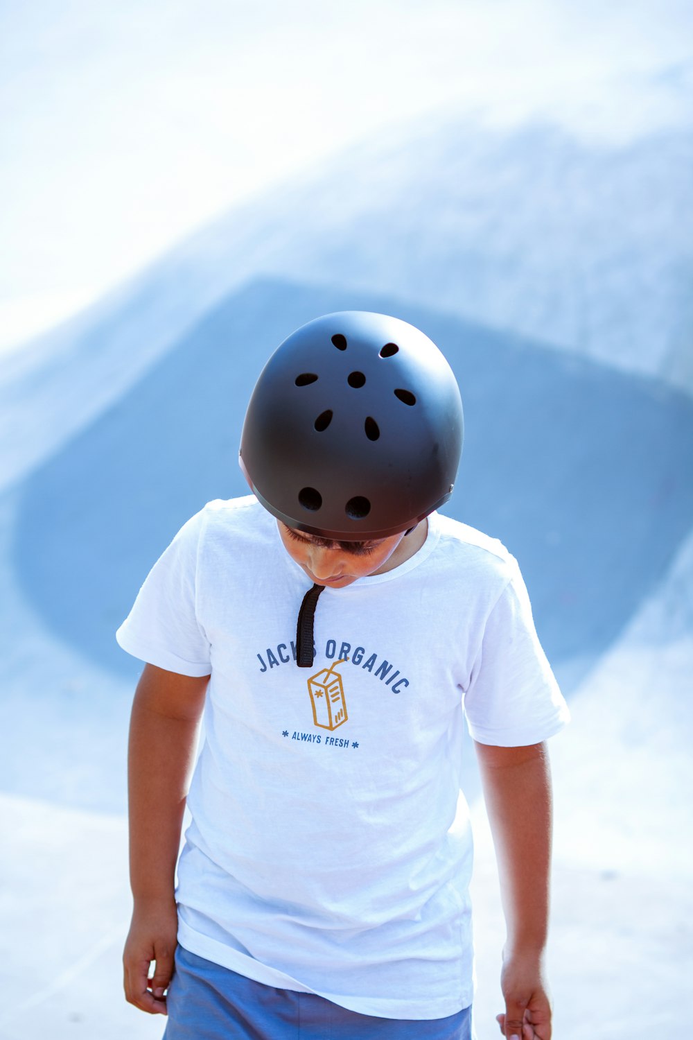 boy in white crew neck t-shirt wearing blue helmet