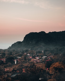 A serene landscape showcasing a picturesque small town with lush greenery and charming houses.