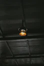 Rustic wooden ceiling beams and soft glowing lamps in the cabin room.