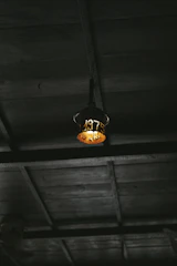 Rustic wooden ceiling beams and soft glowing lamps in the cabin room.