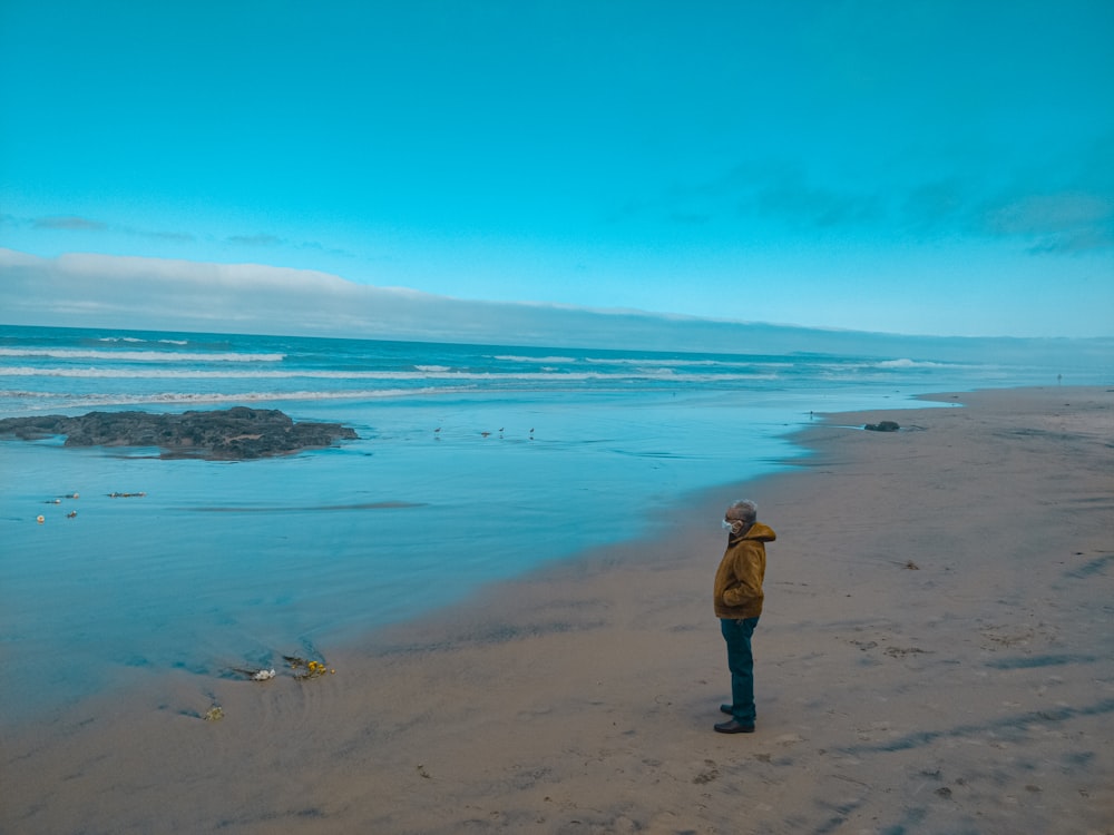 woman in black bikini standing on beach during daytime