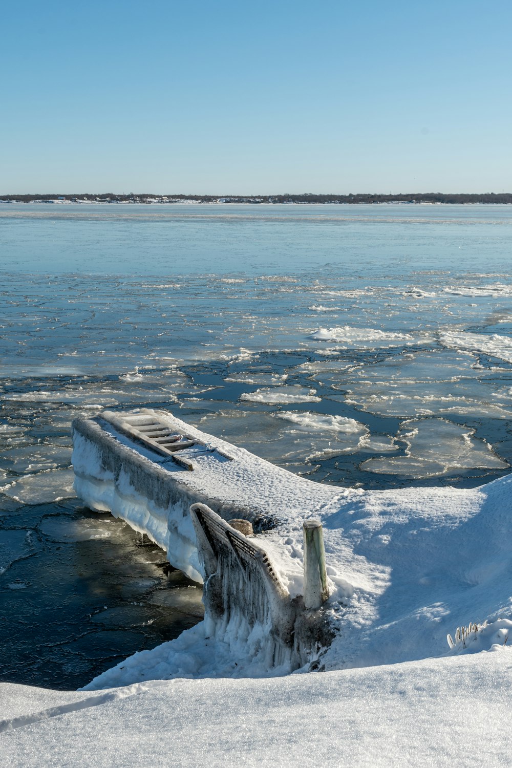 white snow covered mountain near body of water during daytime