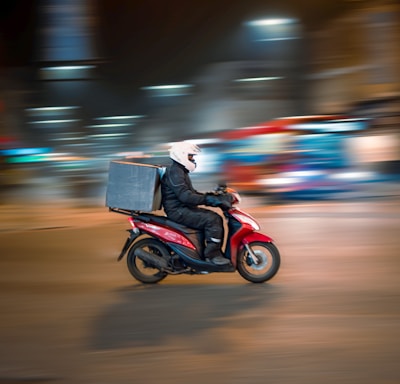 man riding motorcycle on road during daytime