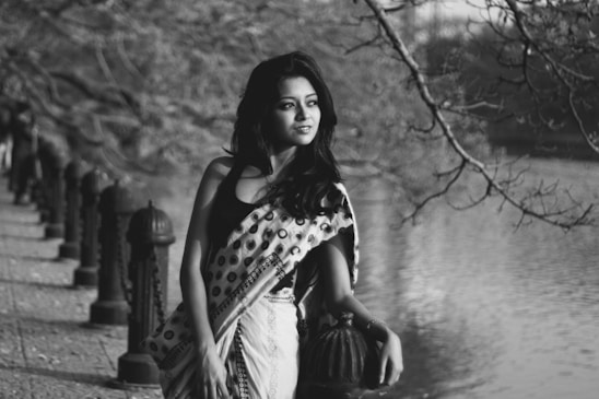 Elegant silhouette of a confident woman against a soft-lit urban backdrop in Rishikesh.