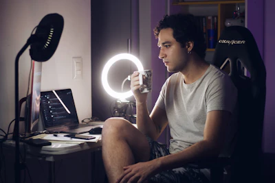 man in gray crew neck t-shirt sitting on chair