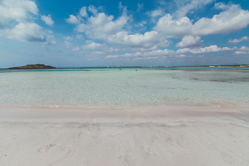 blue sea under blue sky and white clouds during daytime