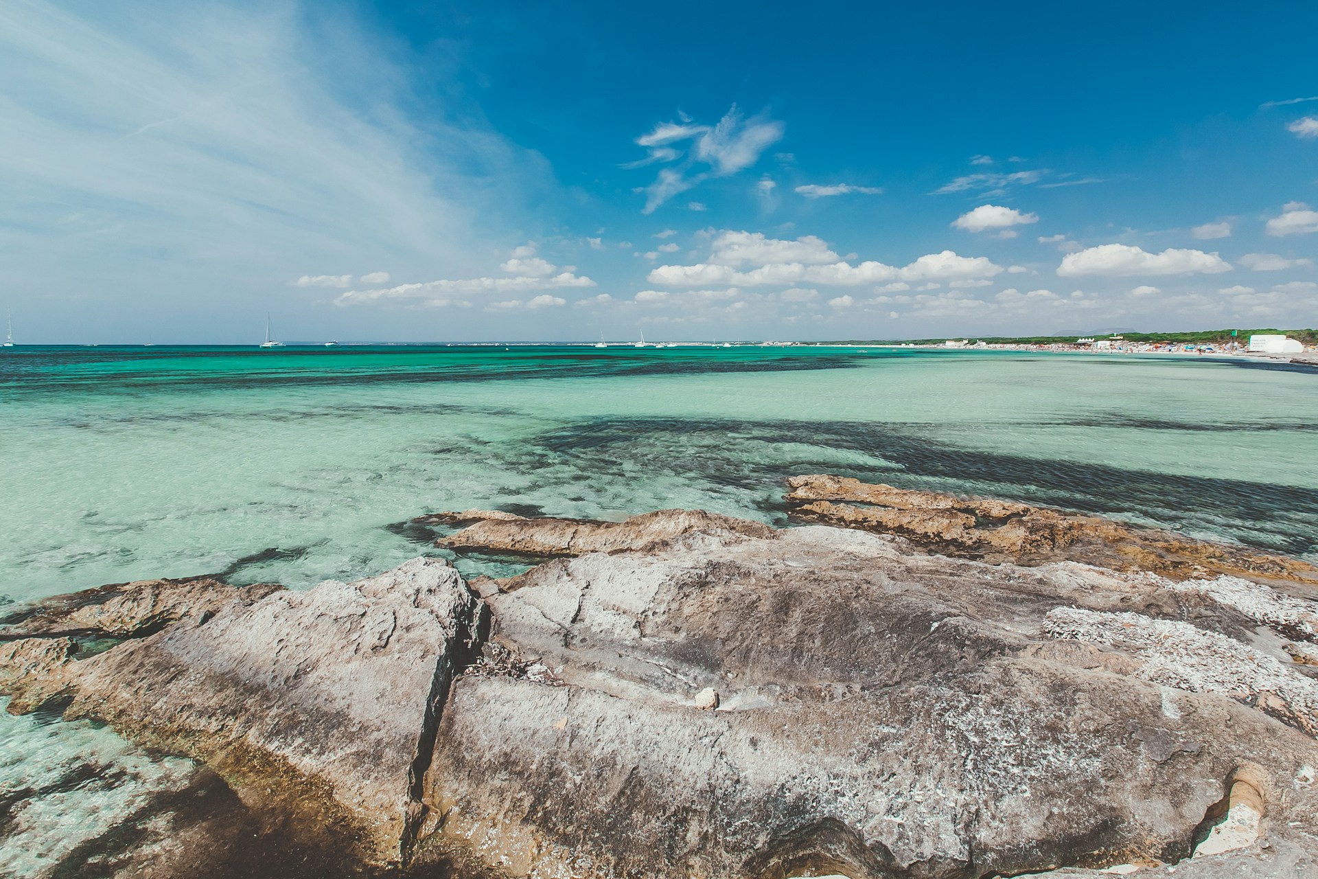 brown rock formation near body of water during daytime