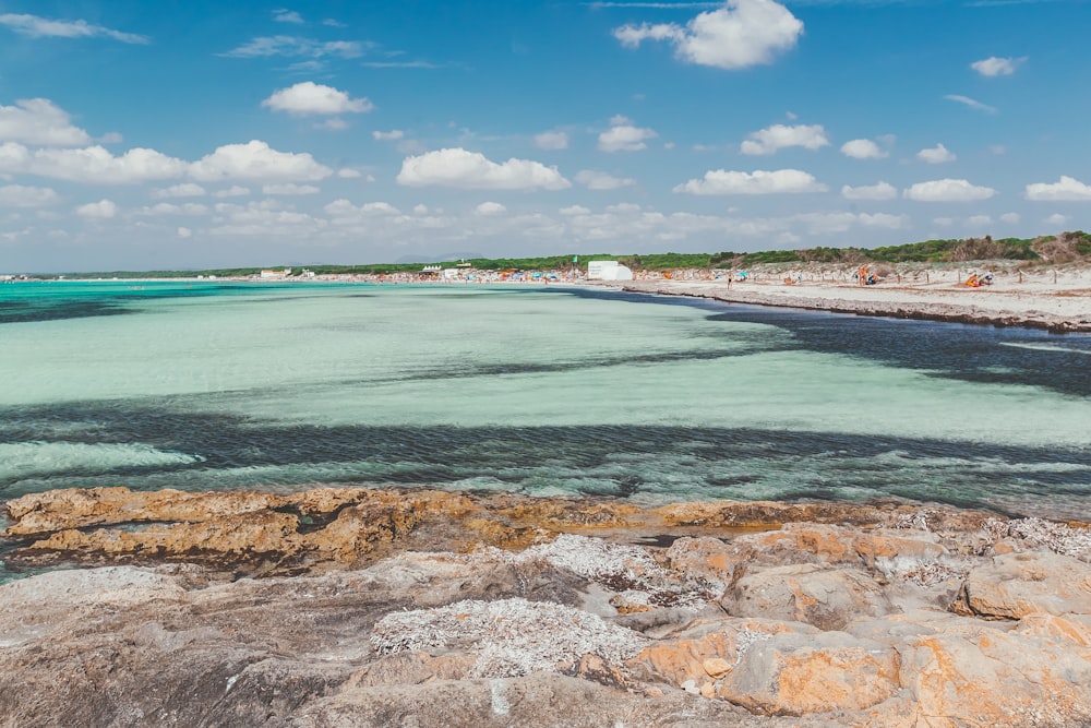 blue sea under blue sky and white clouds during daytime