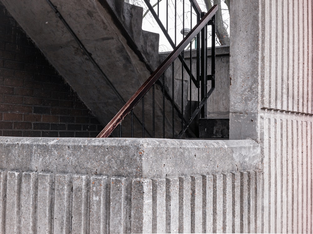 red metal railings on gray concrete staircase