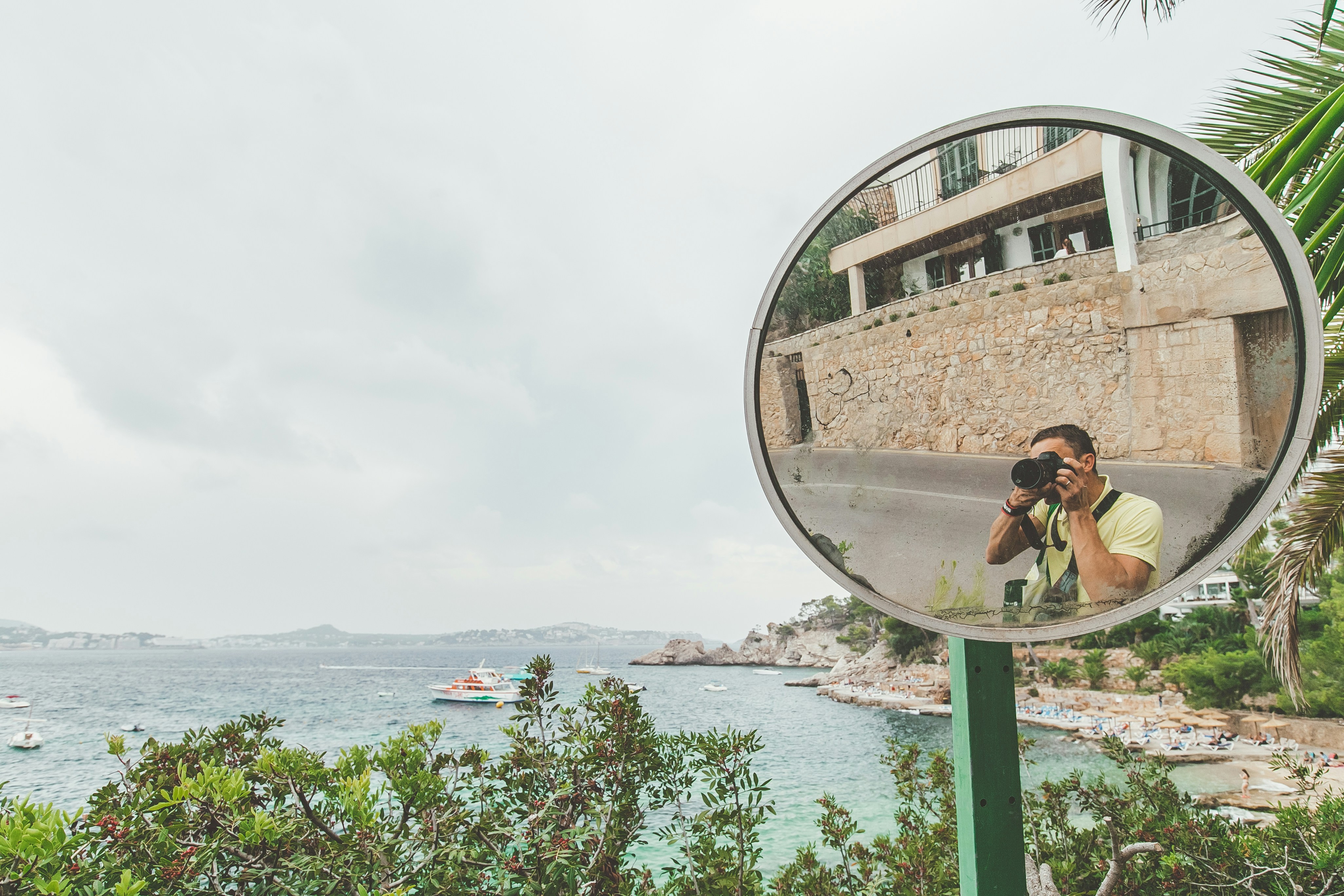 woman in black tank top taking photo of brown concrete building near body of water during, Palma De Mallorca Majorca Majorica Balearic Island landscape sea view beach Azure Blue water sand Summer holidays summer vacation journey with blue sky