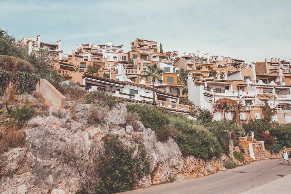 brown and white concrete buildings on mountain during daytime