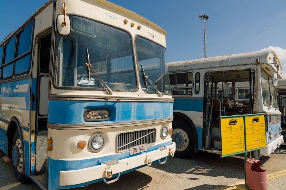 blue and white bus on road during daytime