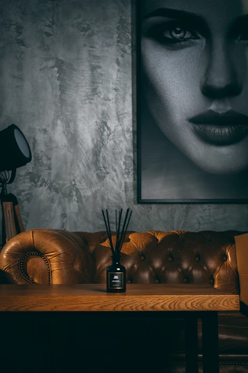 black and silver wireless telephone beside black and silver table lamp on brown wooden table