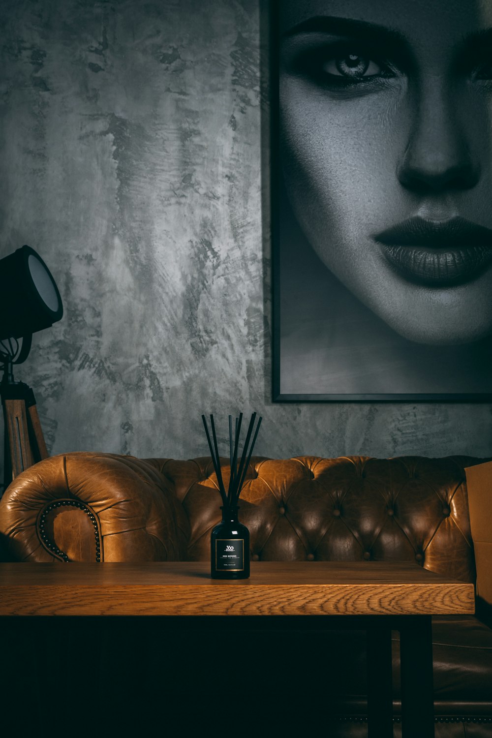 black and silver wireless telephone beside black and silver table lamp on brown wooden table