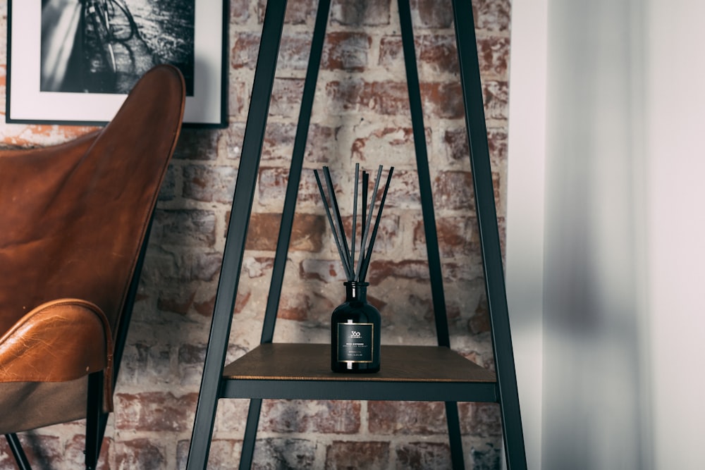 black glass bottle on brown wooden table