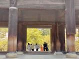A group discussion under a canopy of trees, with sketches and notes on sustainable architecture.