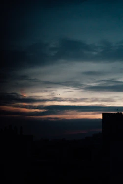 A moody cinematic shot of Karachi’s skyline at dusk with subtle film grain overlay.