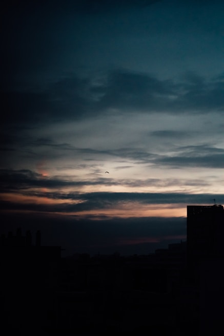 A dramatic skyline at dusk with dark clouds gathering, symbolizing approaching end times