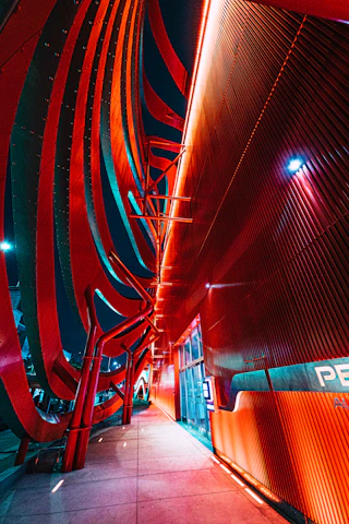 Futuristic smart building facade illuminated with dynamic lighting and digital automation interfaces.