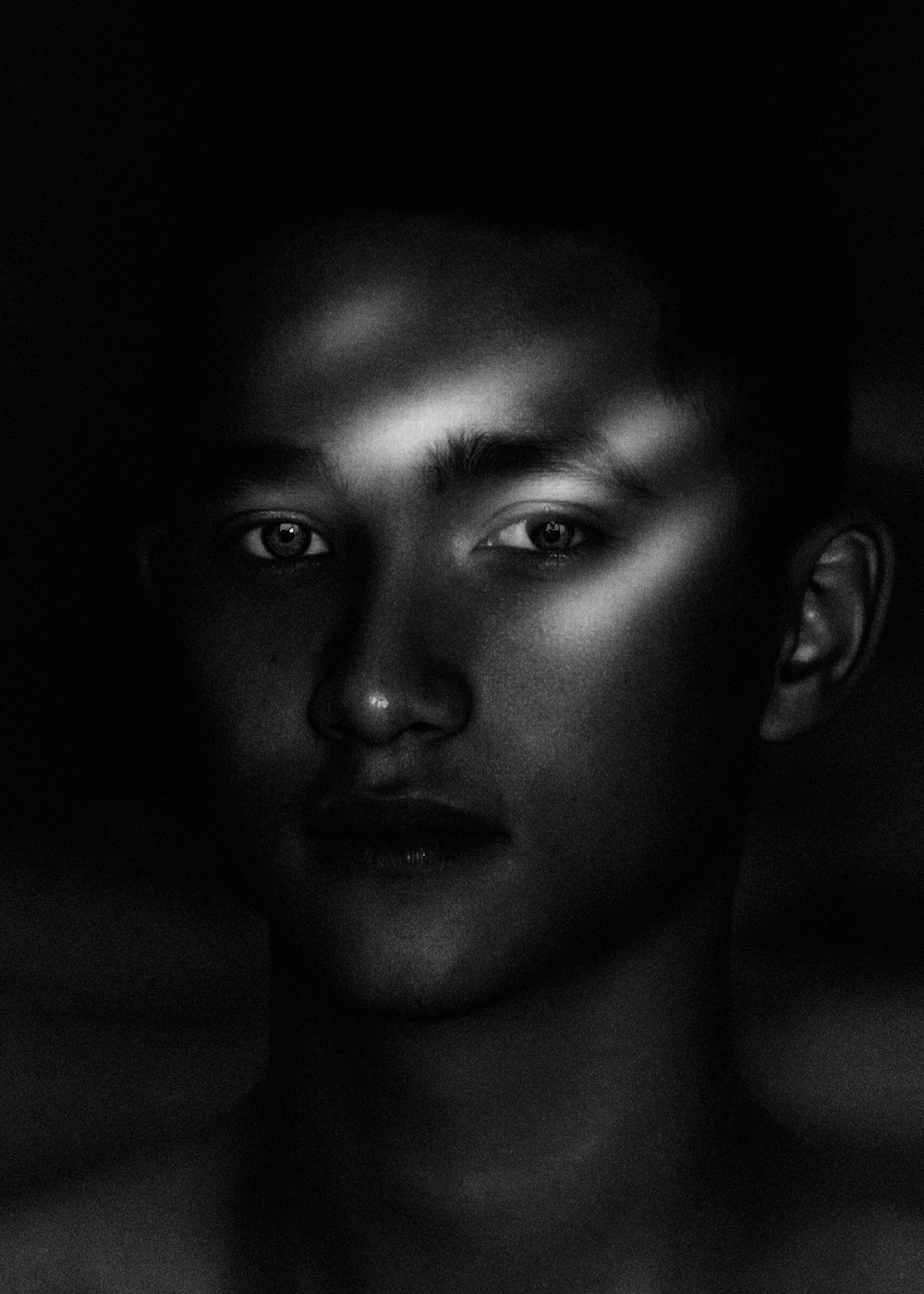 grayscale photo of boys face