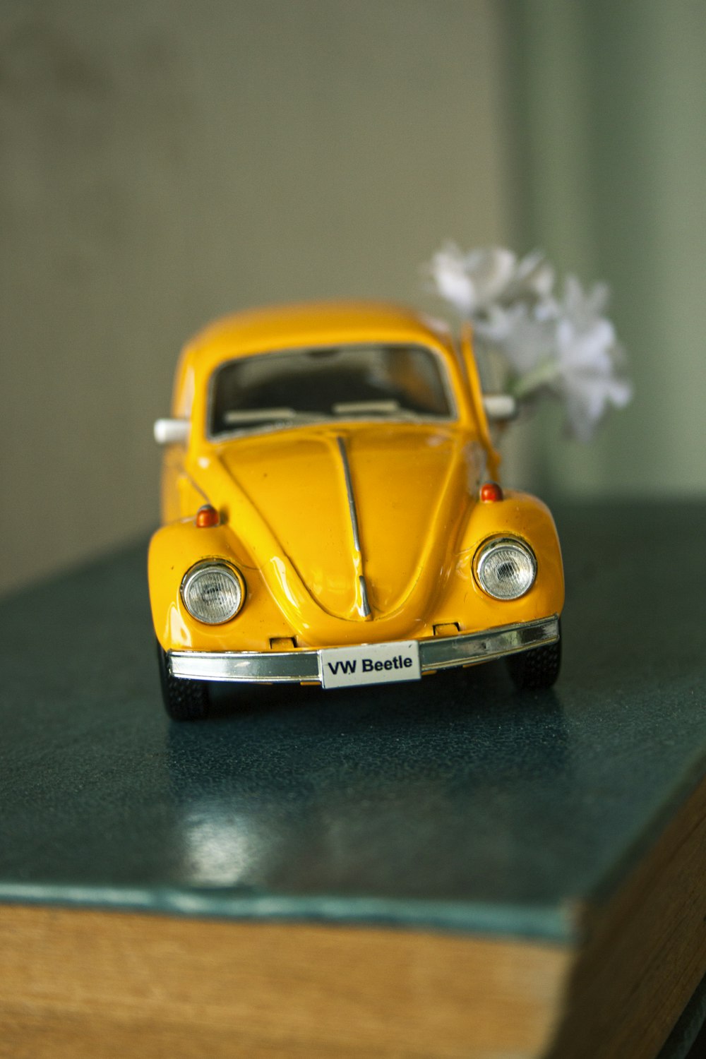 yellow volkswagen beetle on green surface