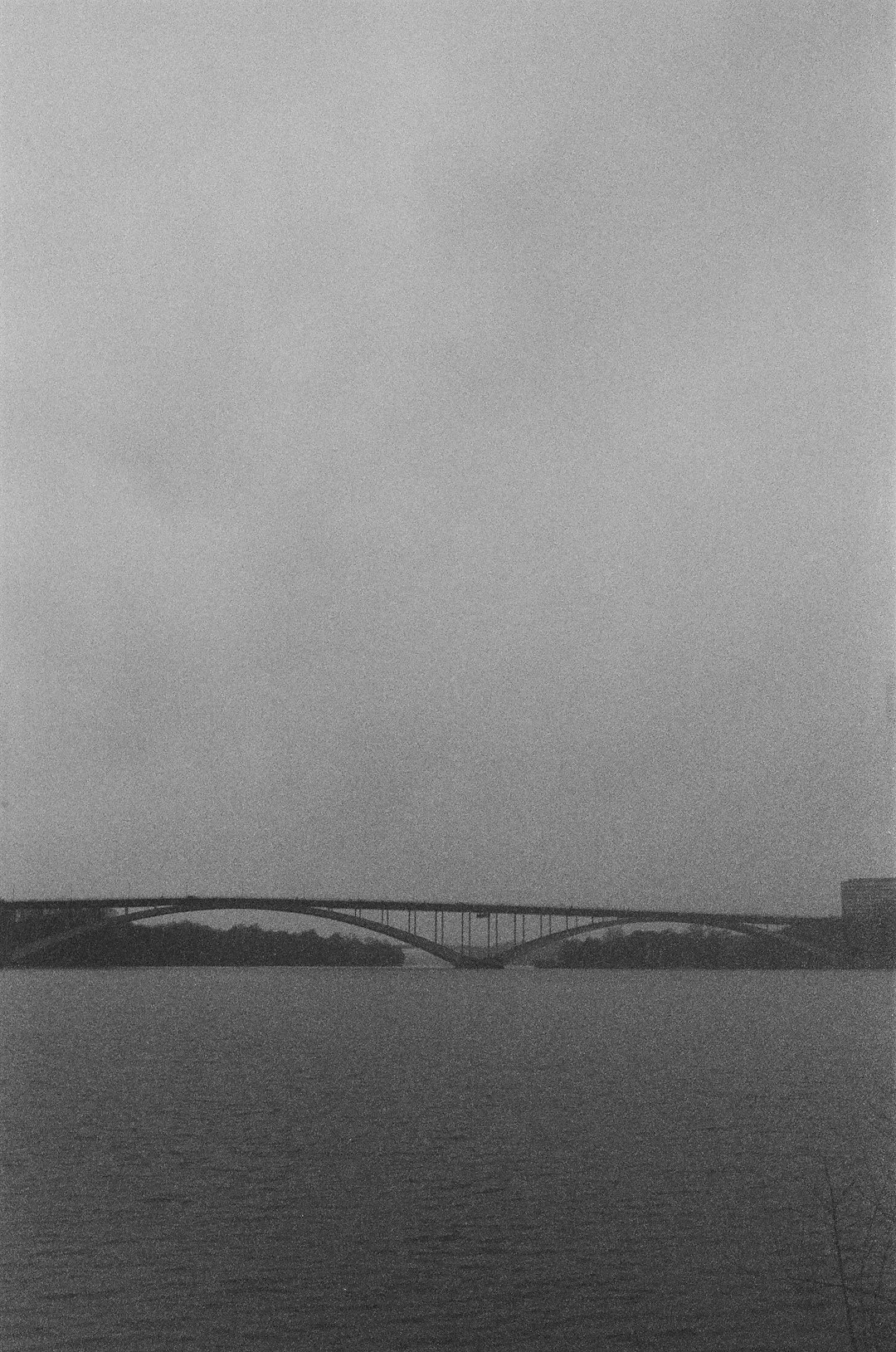 grayscale photo of bridge over water