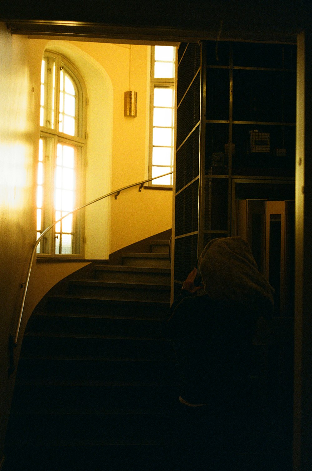 white and brown staircase near white window curtain