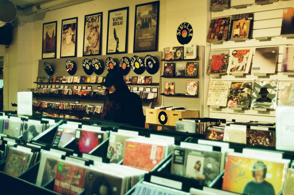 man in black shirt standing in front of store