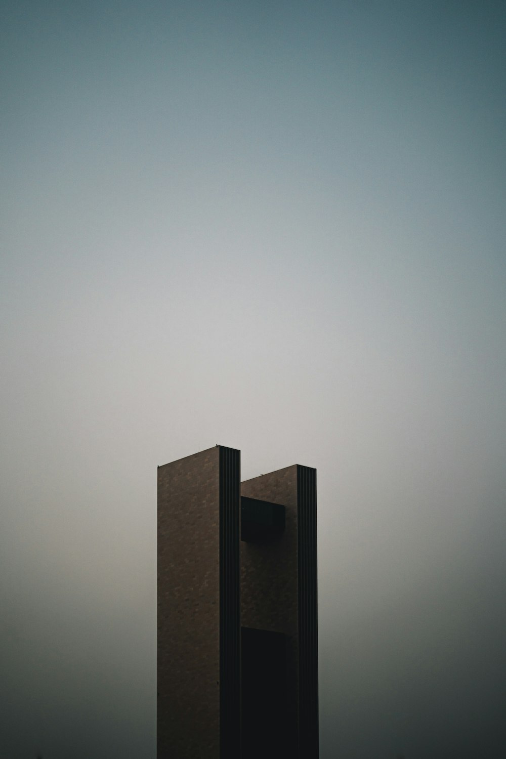 brown concrete building under white sky