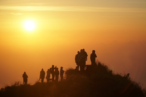 A group of travelers enjoying a sunset.
